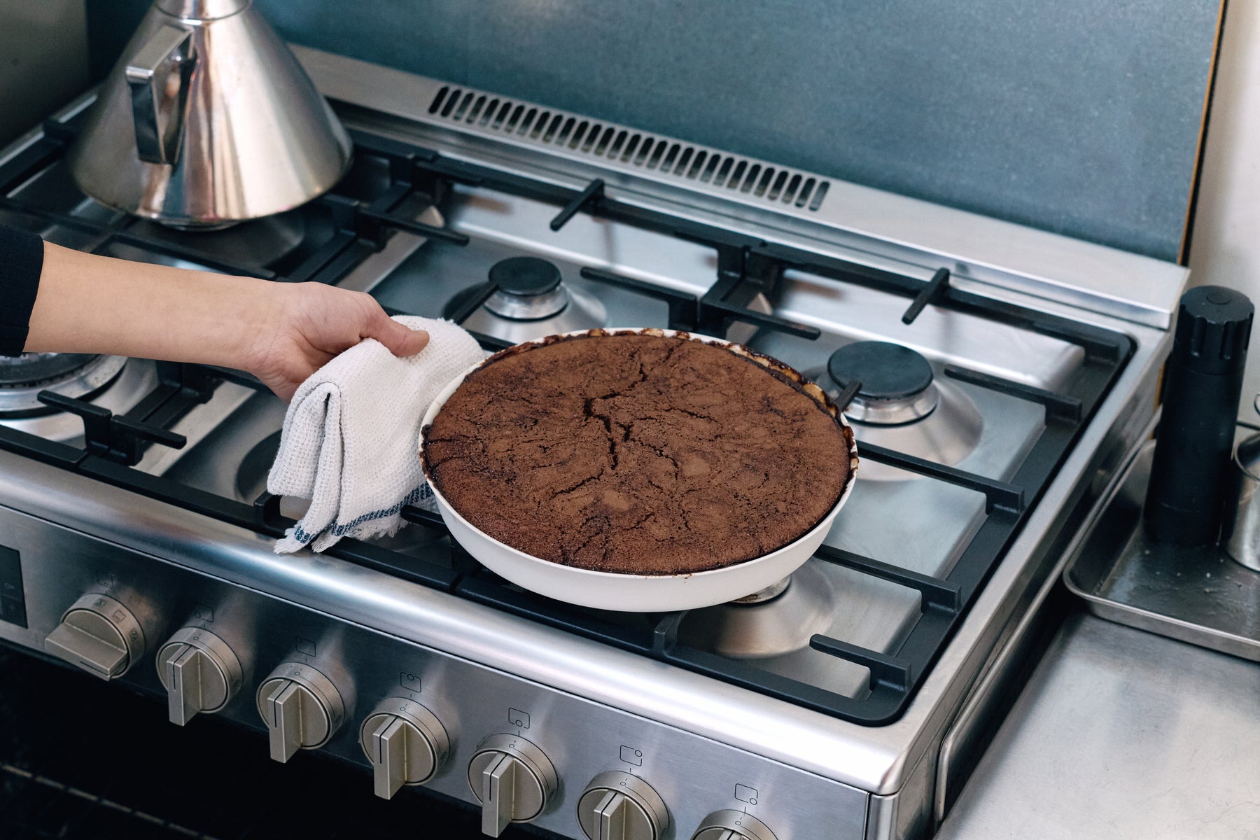Freshly baked chocolate and almond self-saucing pudding in a Mud Flan dish