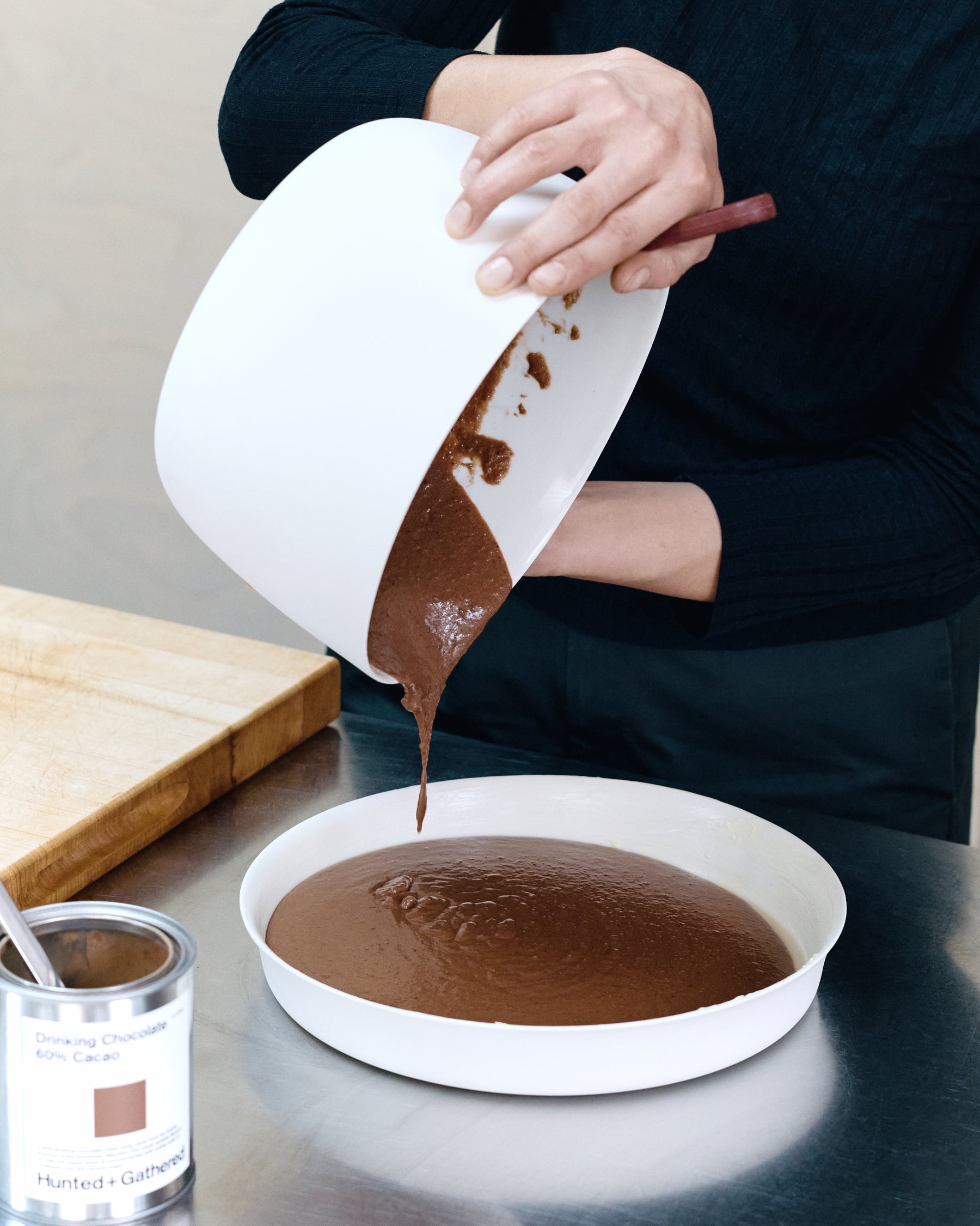 Dom Gattermayr pouring chocolate pudding batter into a Mud Flan dish