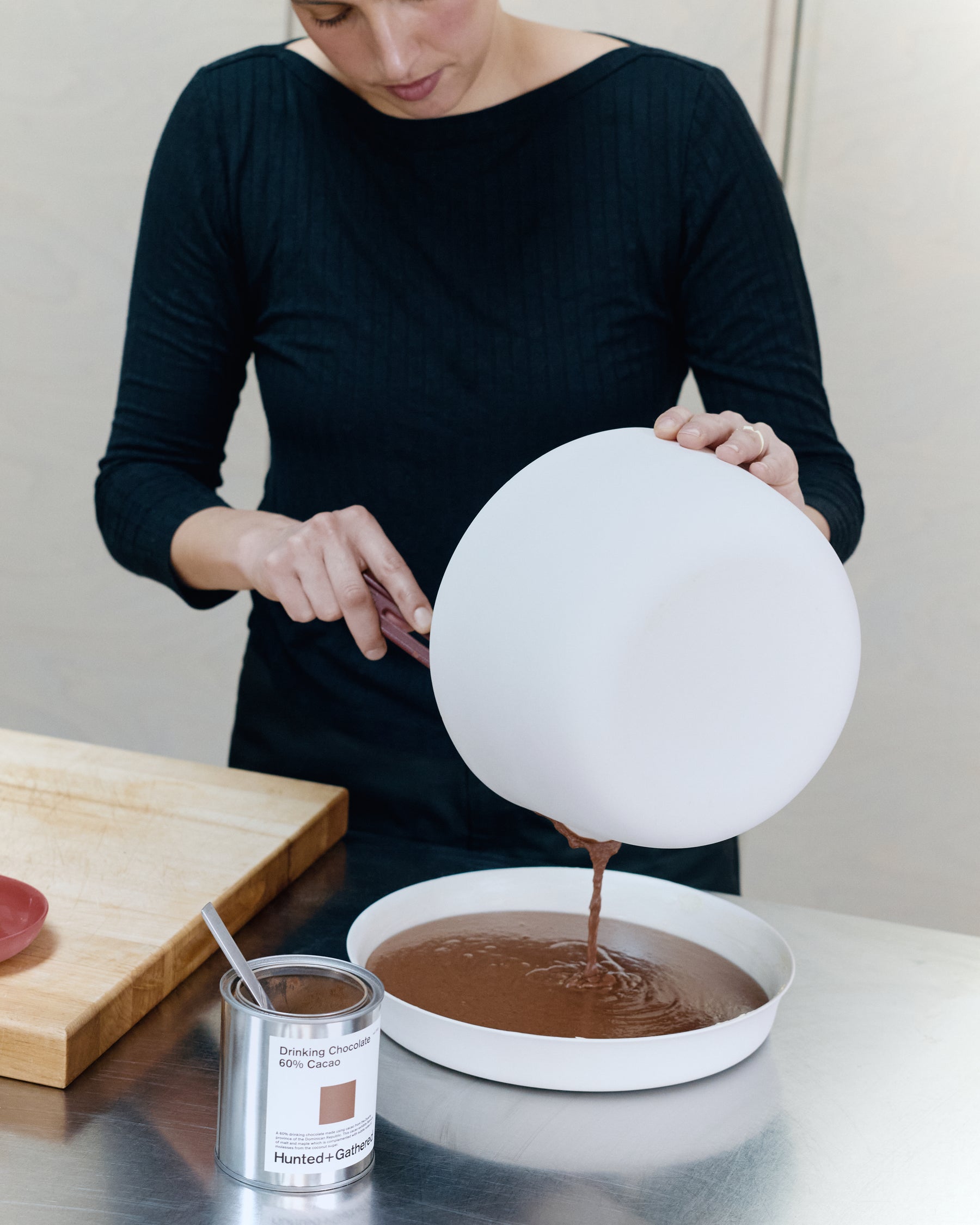 Dom Gattermayr pouring chocolate pudding batter into a Mud Flan dish