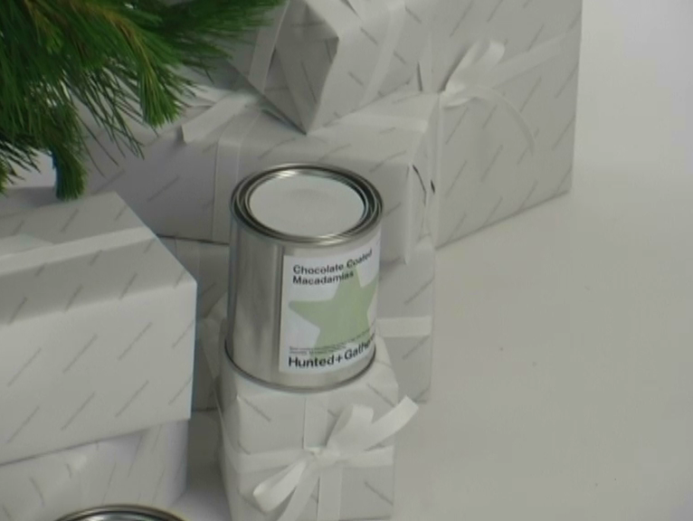 Chocolate Coated Macadamias with wrapped Christmas gifts